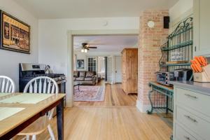 a kitchen and living room with a brick wall at Cozy Elkhart Lake Apartment Walk to Town and Dining in Elkhart Lake