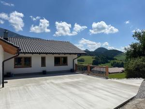 a house with a large patio with a view at Chata Pod Skalkami in Vyšný Kubín