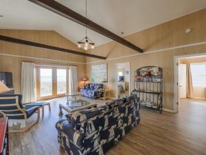 a living room with a couch and chairs and a table at Pelican Perch in Surf City