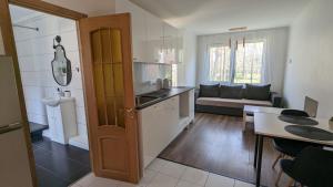 a kitchen and a living room with a table at Pine forest house 8 in Gauja