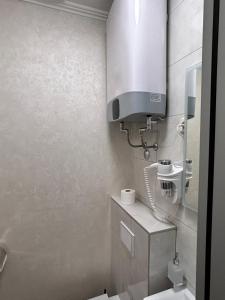a small bathroom with a toilet and a sink at Apartman Studio MiA in Slavonski Brod +5 photos