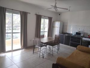 a kitchen and living room with a table and chairs at Belén Apart Hotel in Belén