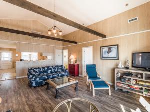 a living room with a couch and a tv at Pelican Perch in Surf City