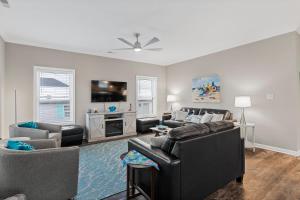 a living room with couches and a flat screen tv at Perfectly SeaSund in Surf City