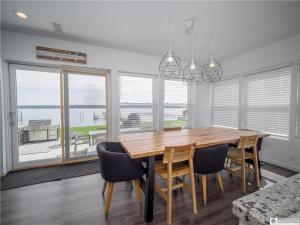 a dining room with a wooden table and chairs at Casa Andante - Lakefront Escape in Mayville