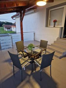 a patio with a table and chairs and stairs at SOBE RIM BREZJE DRAVSKO in Cestica