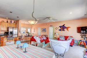 a kitchen and a living room with a red couch at Piccolo Paradiso in Topsail Beach +56 photos