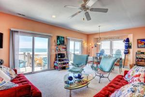 a living room with a couch and chairs and a table at Piccolo Paradiso in Topsail Beach