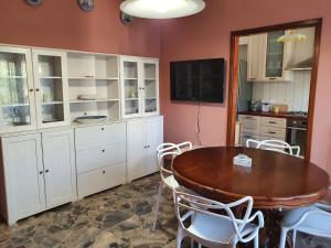 a kitchen with a wooden table and white cabinets at Casa Vacanze Gabry in Porto San Giorgio +16 photos
