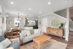 a living room with a couch and a table at Dogwood Cottage by Seabrook Hospitality in Pacific Beach +40 photos