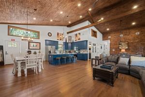 a living room and kitchen with a couch and a table at Terracotta Bliss Wimberley Retreat For 28 Guests in Wimberley