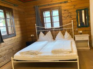 a bedroom with a bed in a log cabin at Bauernhaus 128 Stube 2 Oberkirchleitn by S4y in Sankt Oswald