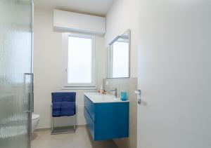 a bathroom with a blue sink and a mirror at VillaBaci sul Mare - Spiaggia privata in Rimini +26 photos