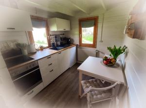 a kitchen with white cabinets and a counter top at Ferienhaus Turner in Neustadt-Glewe