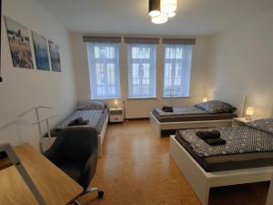 een woonkamer met 2 bedden en een tafel bij Business apartments "An der Lutherkirche" Self-Check-in in Weißenfels