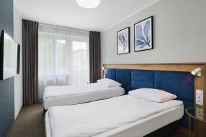 Postel nebo postele na pokoji v ubytování Hotel Halo Toruń + 32 fotografií