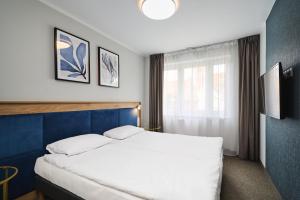Posteľ alebo postele v izbe v ubytovaní Hotel Halo Toruń