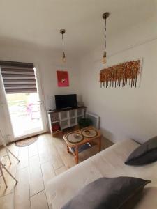 a bedroom with a bed and a table and a television at La casa d'isa in Ducey