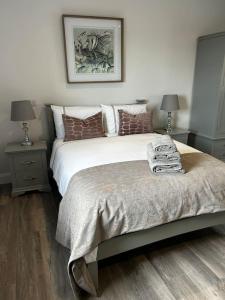 a bedroom with a bed with two night stands and two lamps at Kells Ocean View Luxury Retreat in Kilkeehagh +30 photos