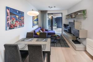 a living room with a table and a dining room at Luxury twin apartments Opatija in Opatija