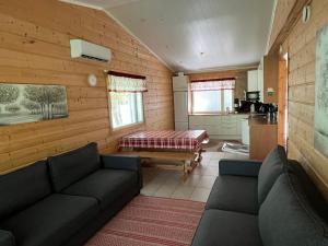 a living room with a couch and a table at Taljatie Apartments in Rovaniemi