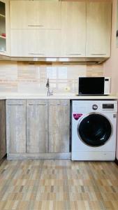 a kitchen with a washing machine and a sink at PANORAMIC view apartment in Tashkent