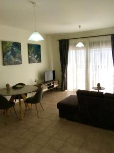 a living room with a couch and a table at Harmonia at Gennadi Court in Gennadi