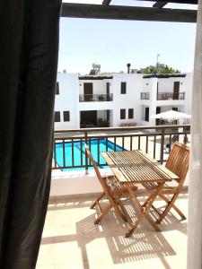 a table and chairs on a balcony with a view of a building at Harmonia at Gennadi Court in Gennadi