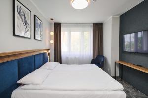 Posteľ alebo postele v izbe v ubytovaní Hotel Halo Toruń