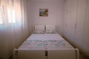 a small bedroom with a bed in a room at Arber's Home in Sarandë