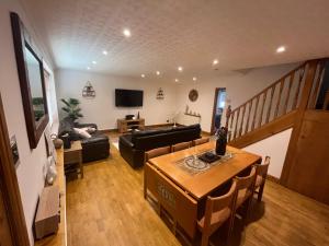 a living room with a table and a couch at Wilford Charm Spacious 3BR Retreat in Nottingham in Nottingham