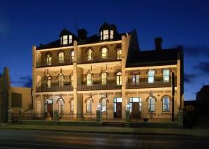 a large building with lights on top of it at Alpine Heritage Motel in Goulburn