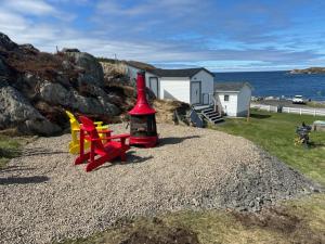 a small house with a playground on top of a rock at PoppyJoe's in Twillingate