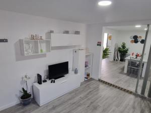 un soggiorno bianco con TV su una parete bianca di Casa Pereira 2 a Ponta do Pargo