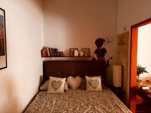 a bedroom with a bed with pillows and a statue at Apartman Nikos in Zadar