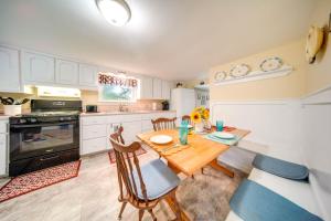a kitchen with a wooden table and a dining room at Lakefront Mayville Cottage with Dock and Grill! in Mayville