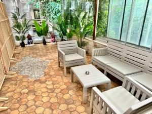 a patio with benches and a table and plants at Otel Kadıköy in Istanbul