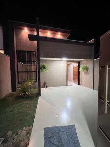 a house with a cross on the front of it at Casa Suítes Beach in Vilhena
