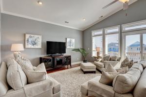 a living room with couches and a flat screen tv at Ripkens Retreat in Surf City