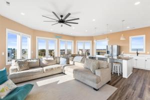 a living room with a couch and a kitchen at Salt & Lime in North Topsail Beach