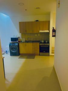 a kitchen with a stove and a dishwasher at Emirates apartment in Dubai +12 photos