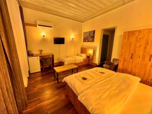 a hotel room with two beds and a desk at Otel Kadıköy in Istanbul