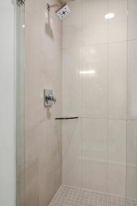 a bathroom with a shower with a glass door at Modern Lifestyle Loft with View - Zuni Lofts in Denver +7 photos
