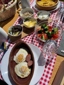 una mesa con un plato de comida con huevos y verduras en Helga's Guesthouse en Lin