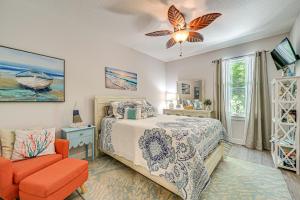 a bedroom with a bed and a chair at Airy Coastal Casa on Park 6 Mi to Honeymoon Isle! in Dunedin