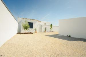 a white house with plants in front of it at VILLA LUXURY MARIA in Roche