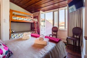 a bedroom with a bunk bed with towels on it at Old City Guest House in Braga