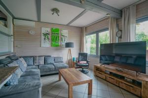 a living room with a couch and a flat screen tv at FH Bären Ecke in Kirchheim