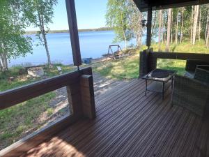 un porche cubierto con vistas al agua en Hanhi Linna en Taivalkoski