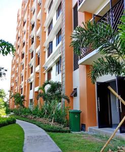 an apartment building with a sidewalk next to a building at Emma's Comfy Space in Manila